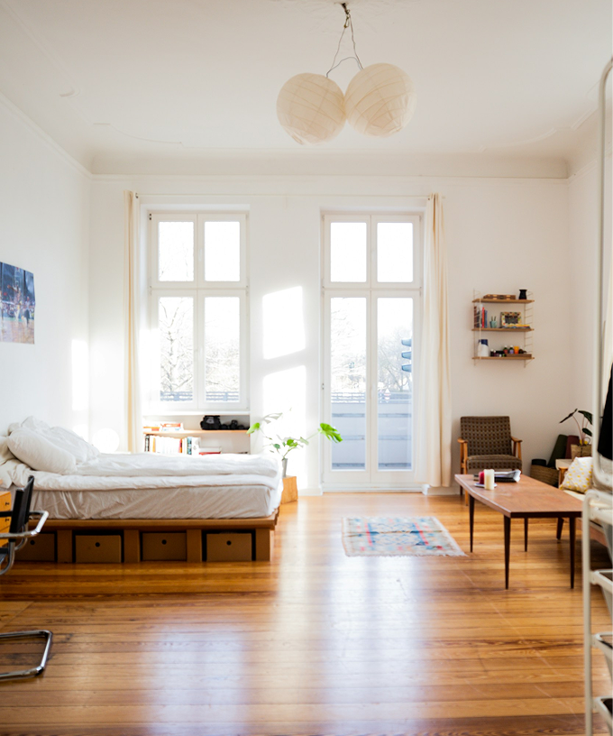 A bright, uncluttered Berlin room with warm wooden floors